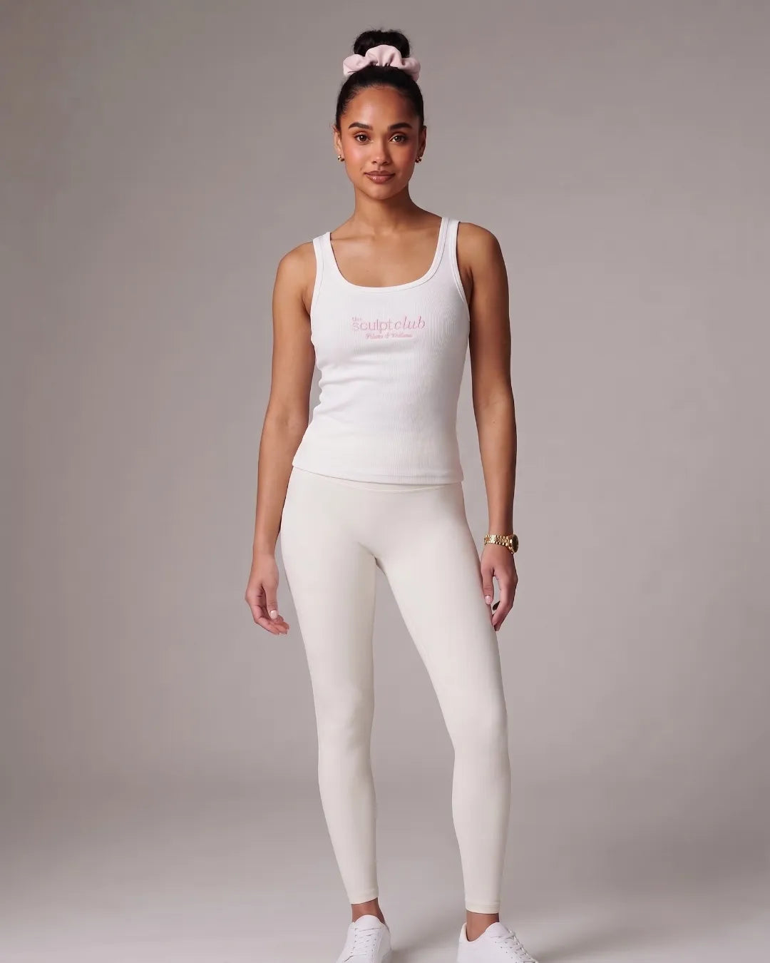 Model wearing TSC white ribbed tank top and white leggings
