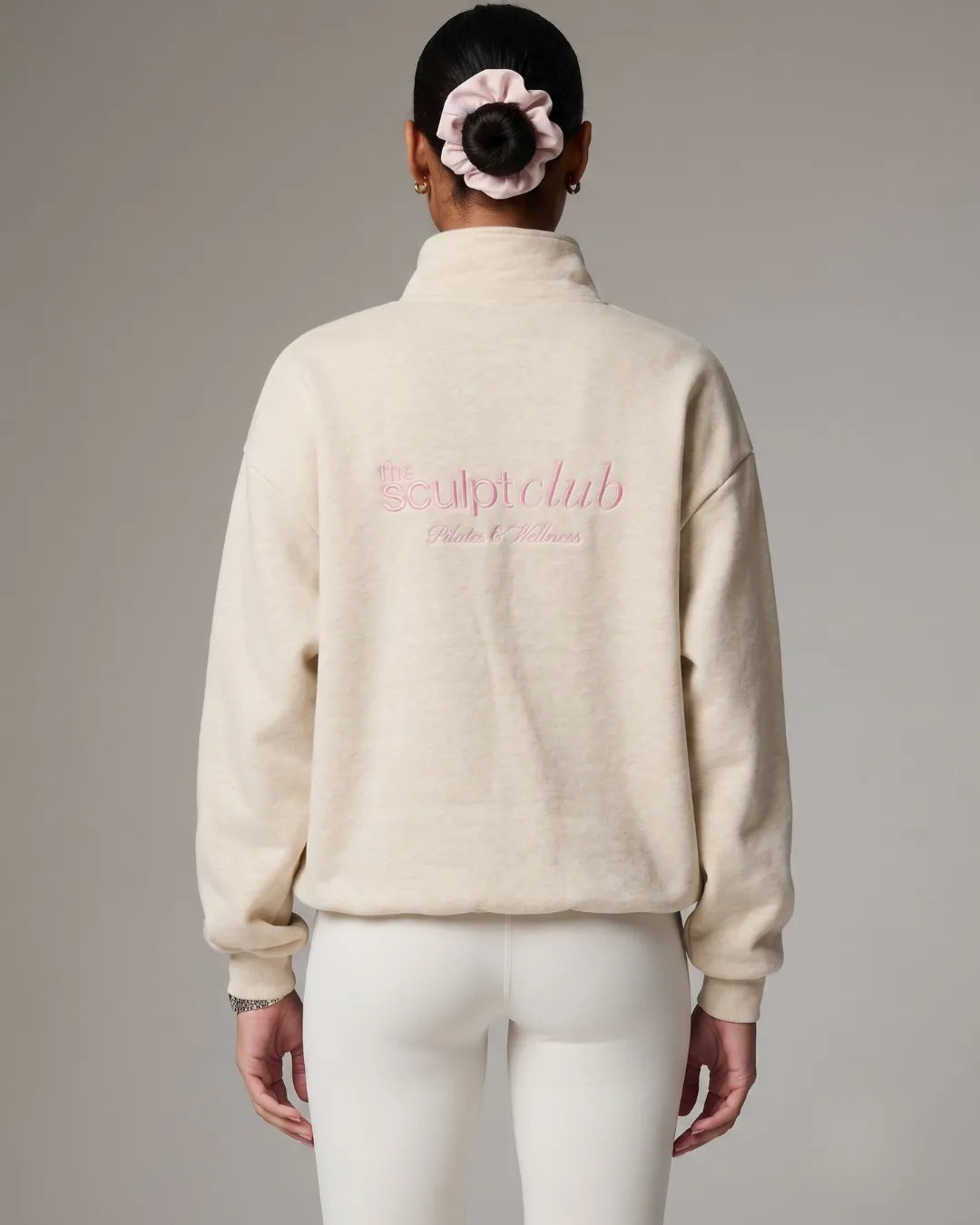 TSC quarterzip in oat worn by model showing back with The Sculpt Club logo