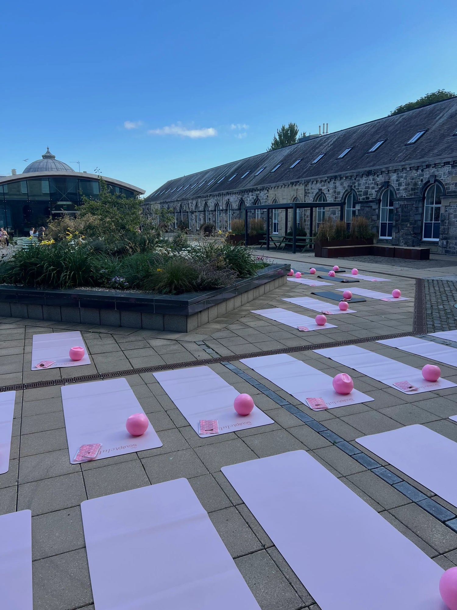 The Sculpt Club outdoor courtyard Pilates event - TSC pink mats and pilates balls set up at Musselburgh venue, East Lothian