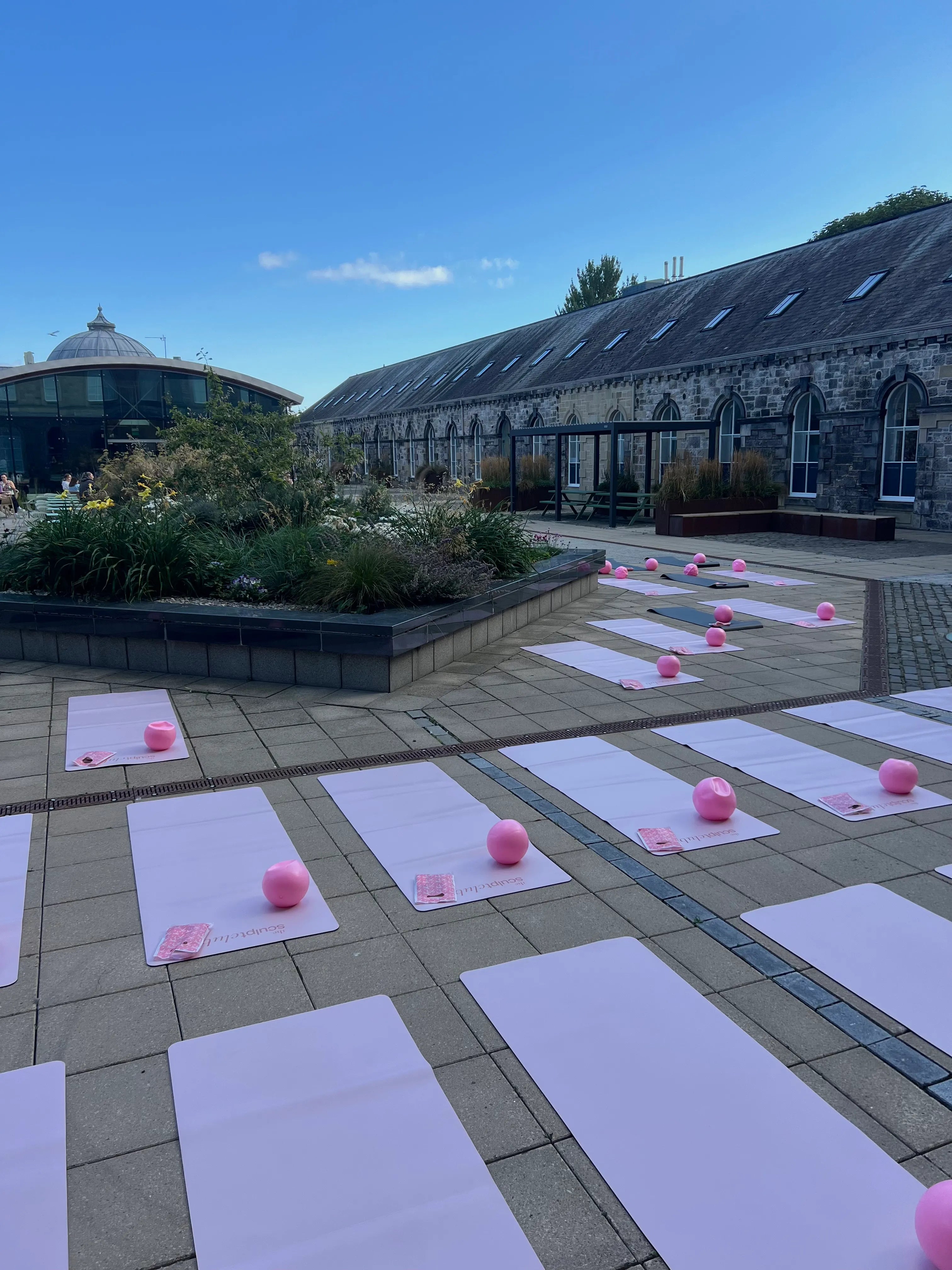 The Sculpt Club outdoor courtyard Pilates event - TSC pink mats and pilates balls set up at Musselburgh venue, East Lothian